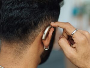 Rotary Ride for Hearing. A person checking their hearing aid